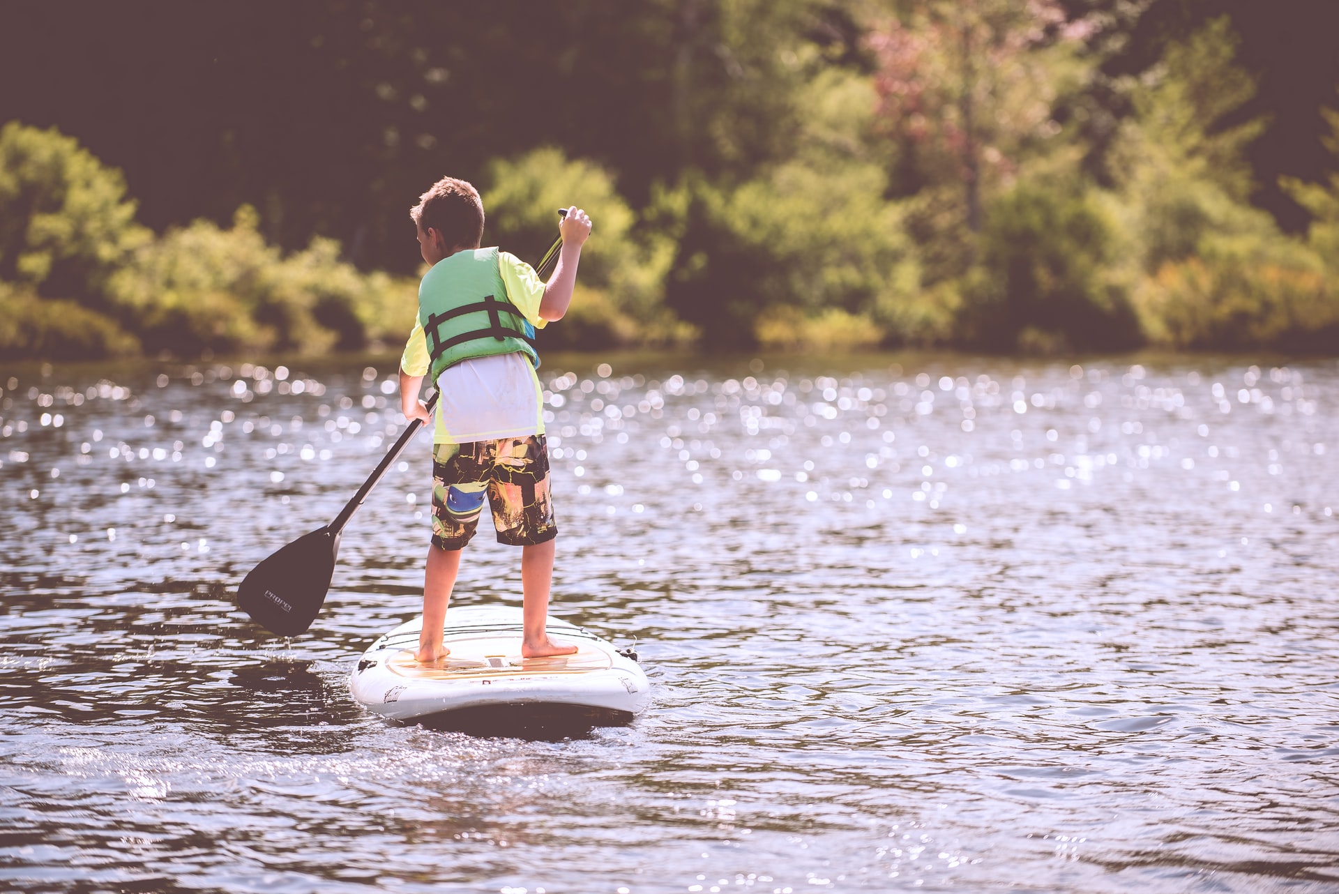 A boy on a paddle board