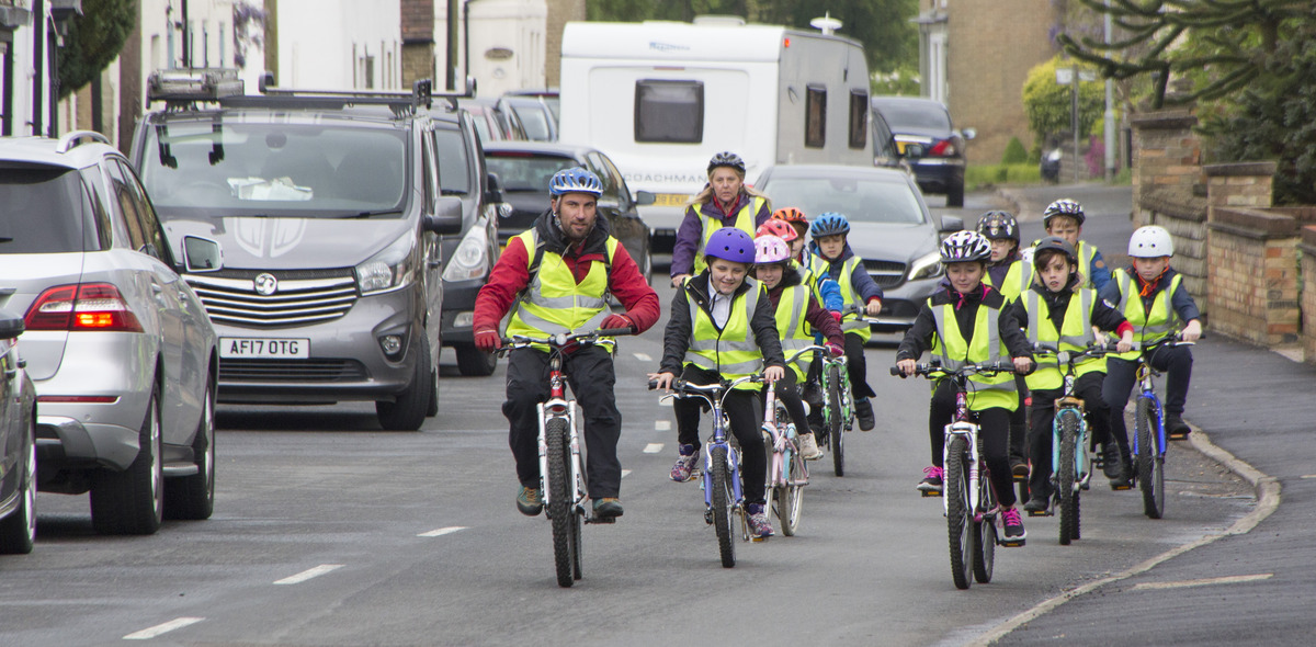 Group of trainees and their instructors cycling on the road (1)